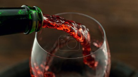 Photo for Pouring red wine into the glass, macro shot. Freeze motion in detail. - Royalty Free Image