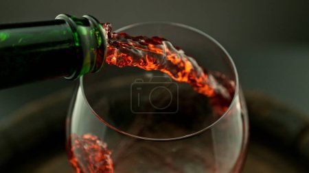 Photo for Pouring red wine into the glass, macro shot. Freeze motion in detail. - Royalty Free Image