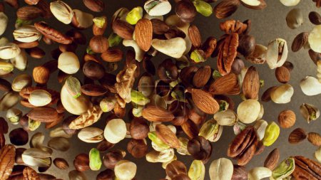 Photo for Freeze motion of flying mix of nuts. Studio shot, colored background. - Royalty Free Image