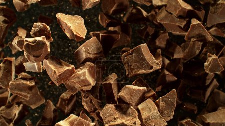 Photo for Freeze motion of flying group of raw chocolate pieces. Isolated on black background - Royalty Free Image