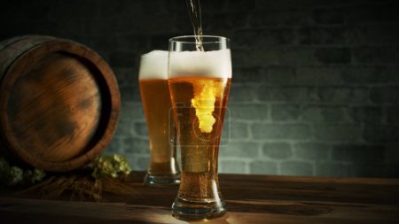 Glass of light beer pouring on wooden table. Still life shot with wooden keg on background.