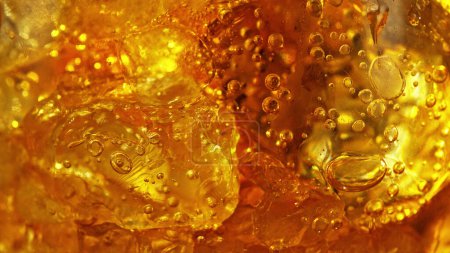 Téléchargez les photos : Detail of cola with ice cubes in glass. Extreme closeup, fresh beverages background. - en image libre de droit