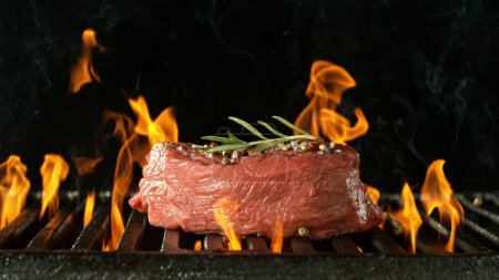 Photo for Barbecue Grill WIth Raw Beef Steak. Barbecue Fire Grid On Black Background. - Royalty Free Image