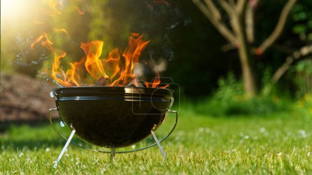 Photo for Barbecue Grill with Fire on Open Air, Placed on Garden. - Royalty Free Image