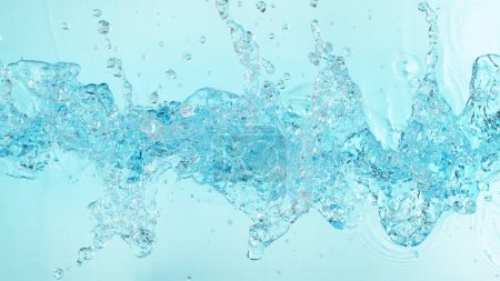 Foto de Salpicaduras de agua abstractas aisladas sobre fondo azul. Congelar el movimiento, composición aérea. - Imagen libre de derechos