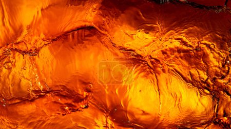 Photo for Liquid golden splash texture, abstract beverages background. Whisky, rum, cognac, tea or oil. - Royalty Free Image