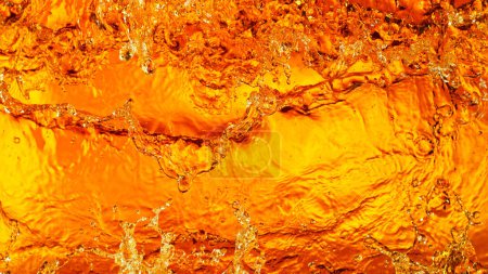 Foto de Liquid golden splash texture, abstract beverages background. Whisky, rum, cognac, tea or oil. - Imagen libre de derechos