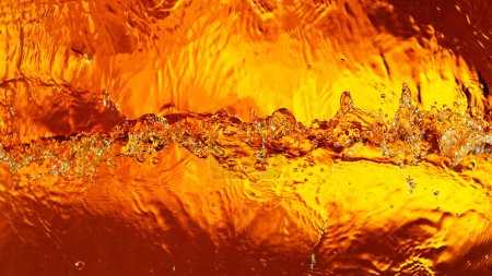 Photo for Liquid golden splash texture, abstract beverages background. Whisky, rum, cognac, tea or oil. - Royalty Free Image