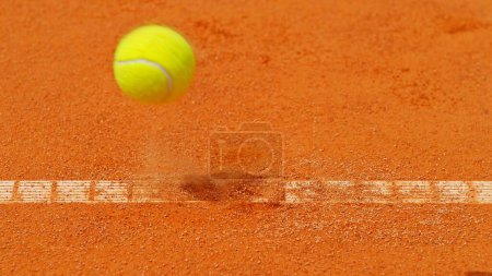 Foto de Congelar el movimiento de la pelota de tenis voladora en la pista. La bola cae en la línea. - Imagen libre de derechos