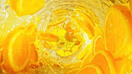 Photo for Texture of splashing water with orange slices. Abstract beverage background, freeze motion. - Royalty Free Image