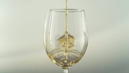 Photo for Pouring White Wine into Glass on Dark Background. Beverages Background. - Royalty Free Image