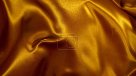 Téléchargez les photos : Élégant tissu de satin doré lisse, Gros plan. Texture du tissu volant, mouvement de gel. - en image libre de droit