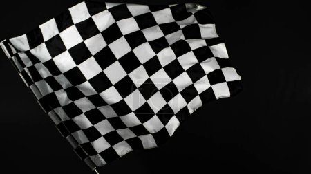 Foto de Bandera de carreras contrastada contra fondo negro. Tiro de estudio. - Imagen libre de derechos