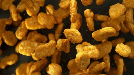 Photo for Falling Nuggets Isolated on Black Background, Selective Focus. Concept of Flying Food. - Royalty Free Image