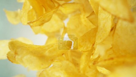 Photo for Flying Fried Potato Chips Levitating in the Air. Concept of Flying Junk Food. Selective Focus. - Royalty Free Image