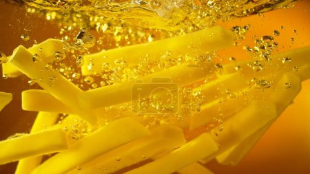 Photo for Freeze Motion of French Fries Floating in Cooking Oil. Junk Food, Fast Food Background. - Royalty Free Image