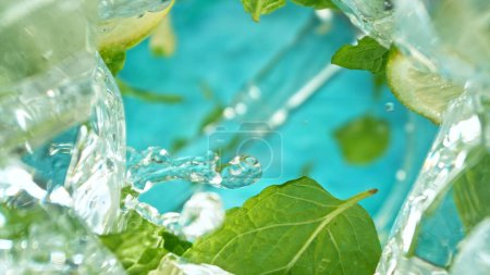Photo for Macro Shot of Mojito Drink Pouring into Glass. Unique Perspective Angle from the Bottom of a Glass. Freeze Motion. - Royalty Free Image