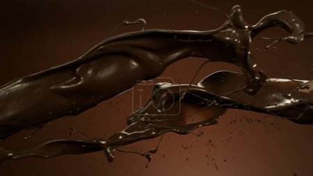 Photo for Melted Chocolate Splashes Flying in the Air. Isolated on Brown Background. - Royalty Free Image