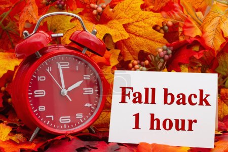 Photo for Fall back 1 hour card with an alarm clock and fall leaves - Royalty Free Image