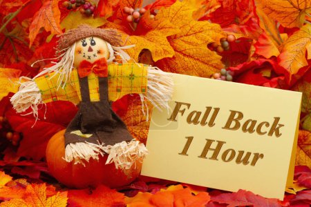 Photo for Fall back 1 hour card with a scarecrow and fall leaves - Royalty Free Image
