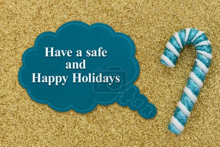 Photo for Have a safe and Happy Holidays sign with teal and white candy cane on gold glitter paper - Royalty Free Image