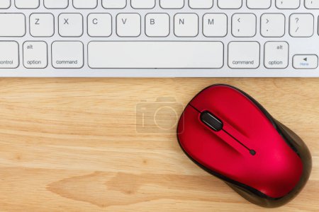 Photo for Red mouse with a keyboard on a wood desk for your online message - Royalty Free Image