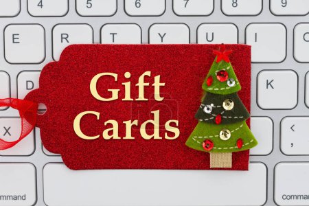 Photo for Gift Cards message on red gift tag with Christmas tree on a keyboard for your holiday online shopping message - Royalty Free Image