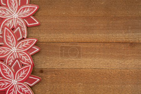Photo for Wood poinsettias on weathered wood holiday background for your winter or seasonal message - Royalty Free Image
