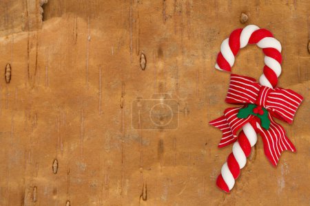Photo for Candy cane on weathered wood holiday background for your winter or seasonal message - Royalty Free Image