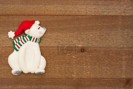 Photo for Cute Santa bear on weathered wood holiday background for your winter or seasonal message - Royalty Free Image