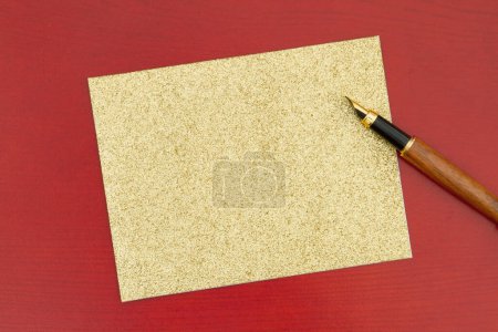 Photo for Blank greeting card on red wood with a fountain pen for your message - Royalty Free Image