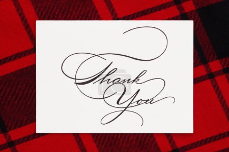 Téléchargez les photos : Carte de vœux sur plaid de buffle rouge pour vos vacances merci - en image libre de droit