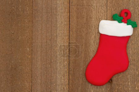 Photo for Christmas stocking on weathered wood holiday background for your winter or seasonal message - Royalty Free Image