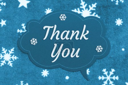 Photo for Thank you message on talk bubble chalk sign on snowflake fabric - Royalty Free Image