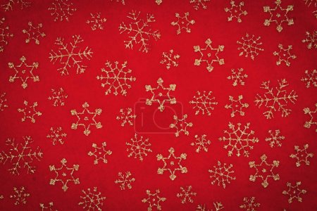 Foto de Copos de nieve dorados sobre fondo de vacaciones de material rojo para su mensaje de invierno o de temporada - Imagen libre de derechos