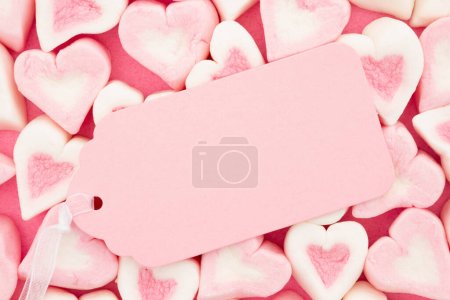 Blank pink gift tag with pink and white candy hearts for your valentine or anniversary message