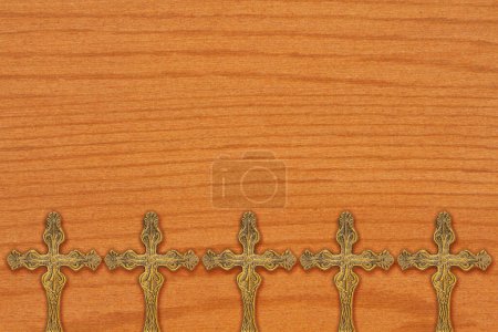 Photo for Bronze religious cross background on wood for your faith and religion message - Royalty Free Image