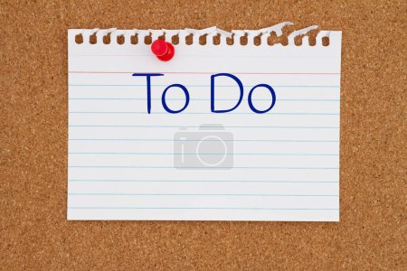 Photo for To Do message on ruled paper with a pushpin on a corkboard with space for your message or information - Royalty Free Image