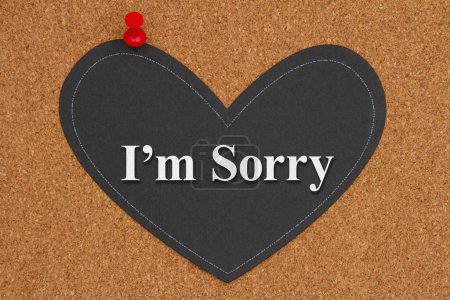 Photo for Im sorry message on chalkboard heart with a pushpin on a corkboard - Royalty Free Image