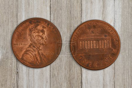 Photo for Close-up of two USA pennies both sides on weathered wood for your two cents message - Royalty Free Image