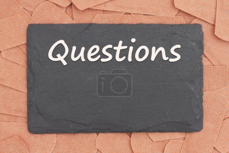 Photo for Questions message on a chalkboard with lots of fabric adhesive band aids with for your medical or injury message - Royalty Free Image