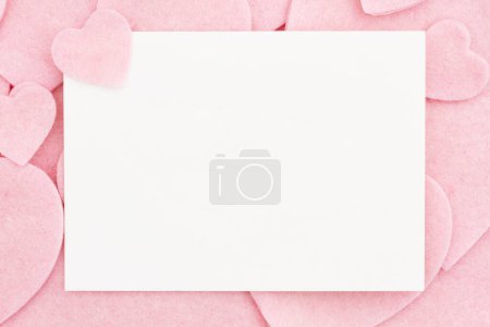 Photo for Blank greeting card with lots of felt pink hearts with space for your message - Royalty Free Image