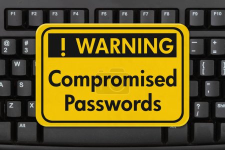 Photo for Comprised Passwords message on a yellow warning sign a computer keyboard - Royalty Free Image