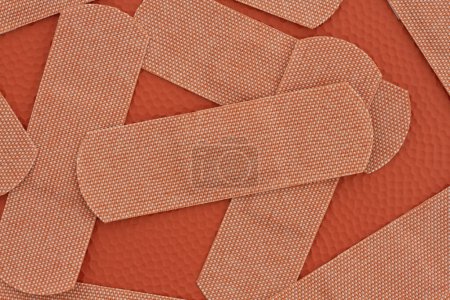 Photo for Lots of fabric adhesive band aids background with for your medical or injury message - Royalty Free Image