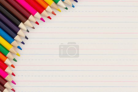 Photo for Color pencils on vintage ruled line notebook paper background for you education or school message - Royalty Free Image
