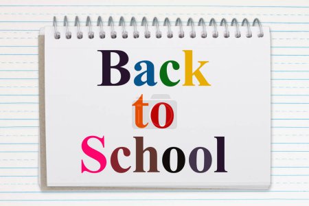 Photo for Back to school message on a notepad on double lined paper - Royalty Free Image