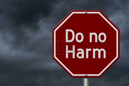 Photo for Do no harm message on red street stop sign with stormy sky - Royalty Free Image