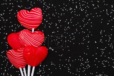 Photo for Red and white candy heart lollipop love background for your valentine or anniversary message - Royalty Free Image
