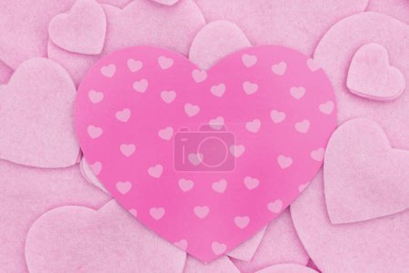 Photo for Lots of pink felt hearts with paper heart love background for your romance or dating message - Royalty Free Image