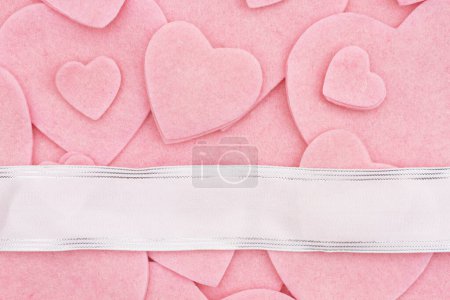Photo for Lots of pink felt hearts with silk banner love background for your romance or dating message - Royalty Free Image